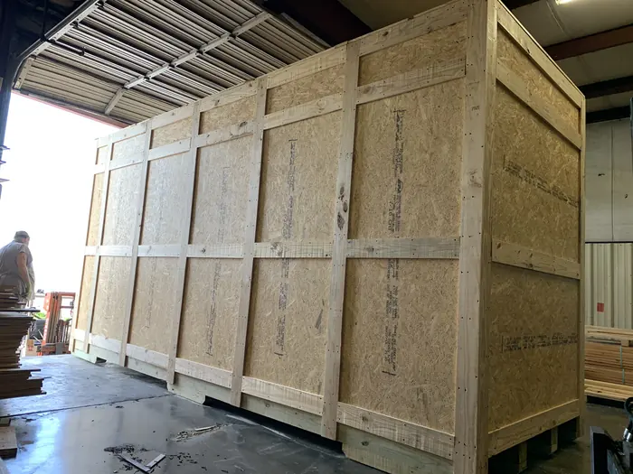 A large enclosed crate nearing completion.