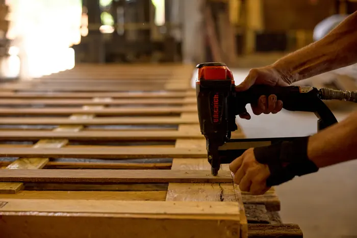 Decking a pallet by hand.